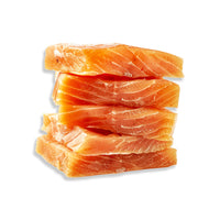 A stack of five raw salmon fillets with visible white fat marbling, set against a plain white background.