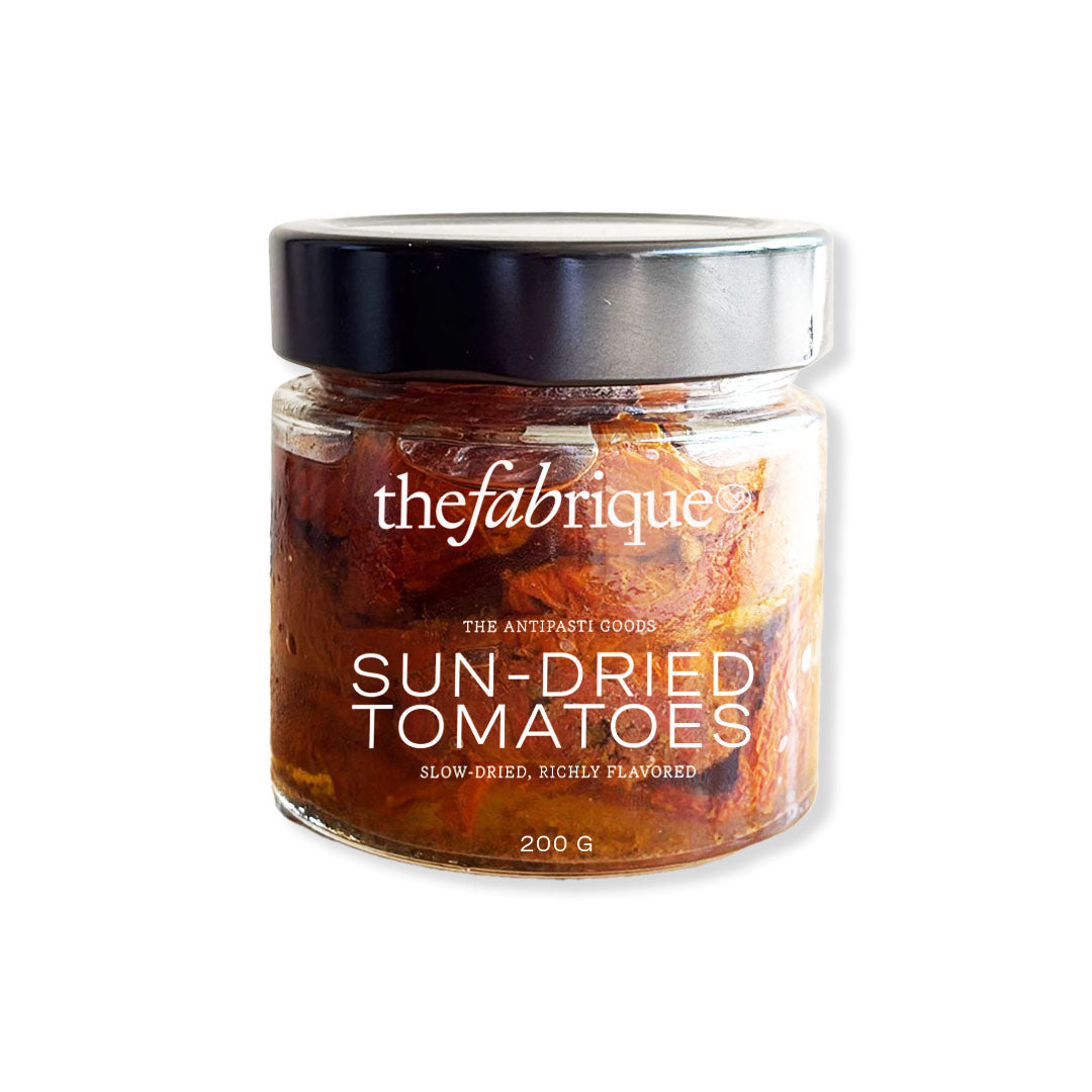 Jar of sun-dried tomatoes with 'thefabrique' branding on a white background