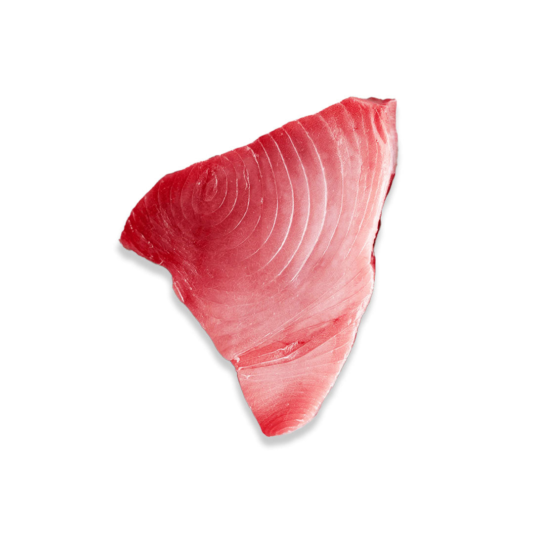 A single raw tuna fillet slice with a vibrant red-pink color and visible muscle striations, isolated on a white background with a soft drop shadow.